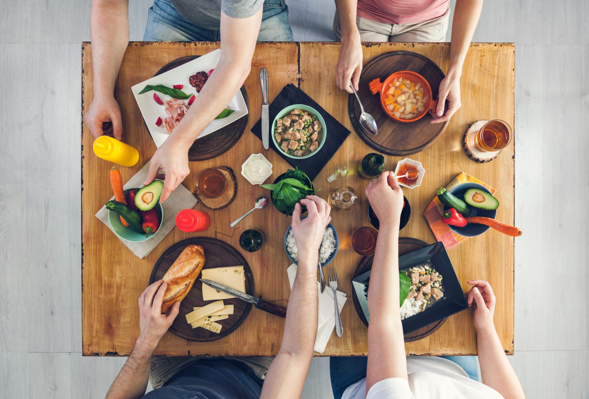 Top view, Group of people sitting at the table having meal Top view, Group of people sitting at the table having meal